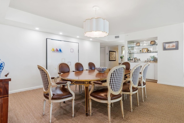 dining room featuring light carpet