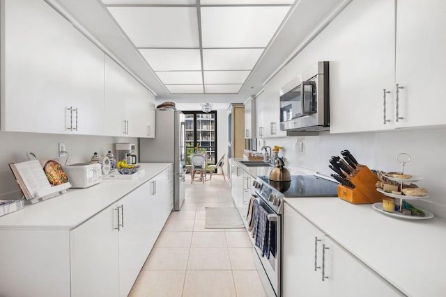 kitchen with appliances with stainless steel finishes and white cabinets