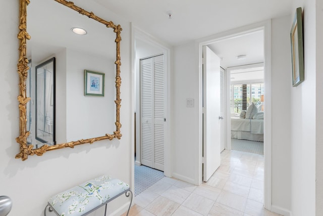 corridor with light tile patterned floors