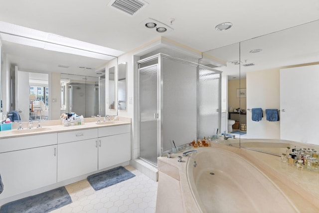 full bathroom featuring vanity, separate shower and tub, and toilet