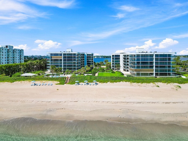 bird's eye view featuring a water view and a beach view