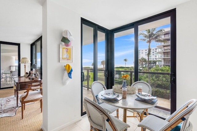 tiled dining area featuring floor to ceiling windows