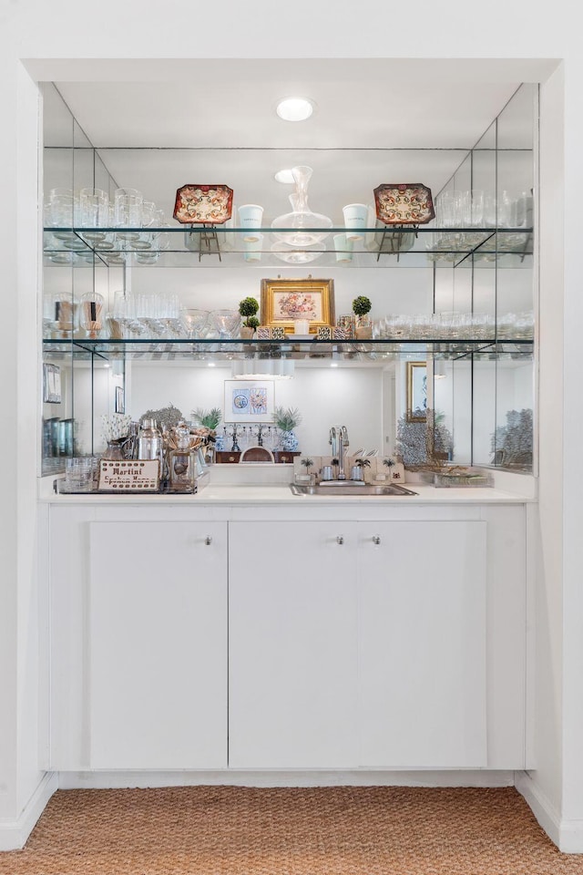 bar with white cabinets and sink