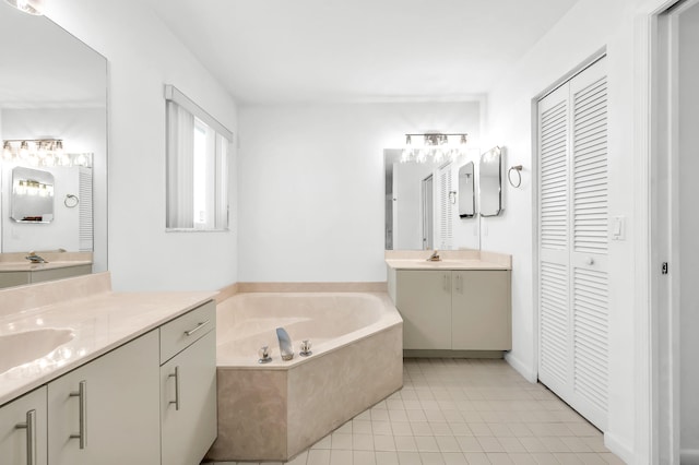 bathroom featuring a bath, tile patterned flooring, and vanity