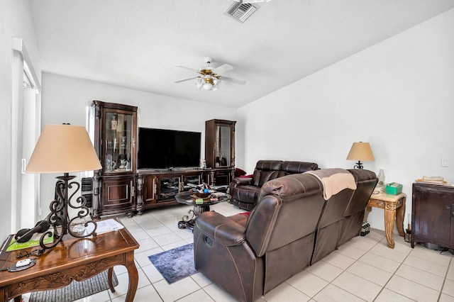 tiled living room featuring ceiling fan and a textured ceiling