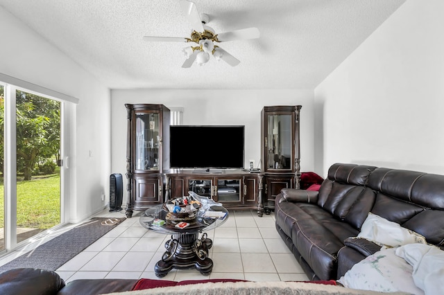 tiled living room with a textured ceiling and ceiling fan