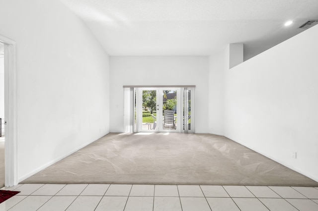 carpeted spare room with a textured ceiling