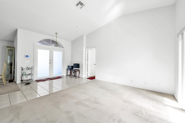 tiled foyer with french doors, vaulted ceiling, and a wealth of natural light