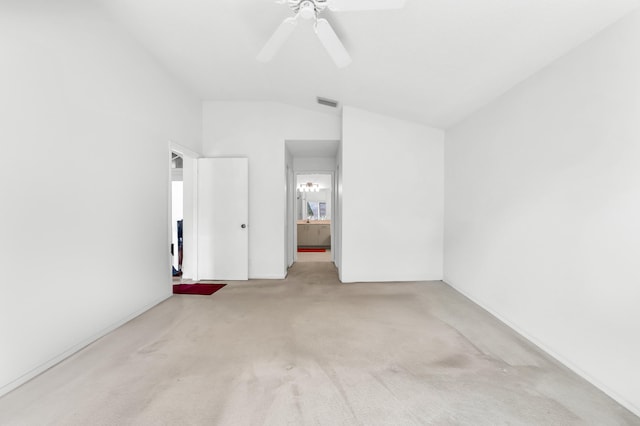 carpeted spare room with lofted ceiling and ceiling fan