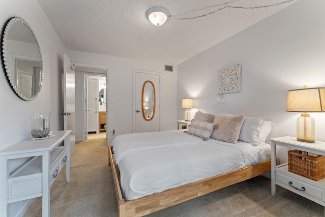 bedroom featuring a textured ceiling and carpet