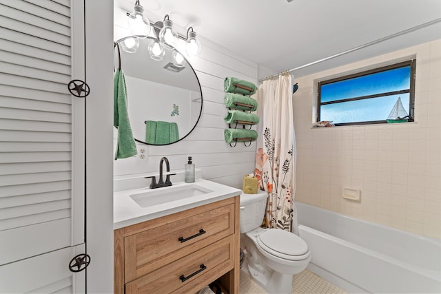 full bathroom featuring shower / tub combo with curtain, tile patterned floors, vanity, and toilet