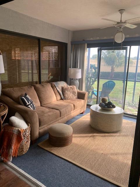 sunroom featuring ceiling fan