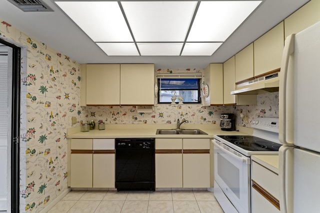 kitchen featuring white appliances, sink, light tile patterned flooring, and cream cabinetry