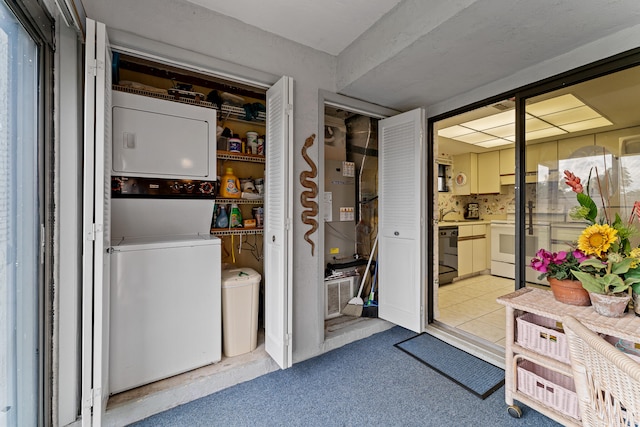 laundry room featuring stacked washer / dryer