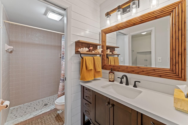 bathroom featuring vanity, wooden walls, tile patterned floors, toilet, and a shower with shower curtain