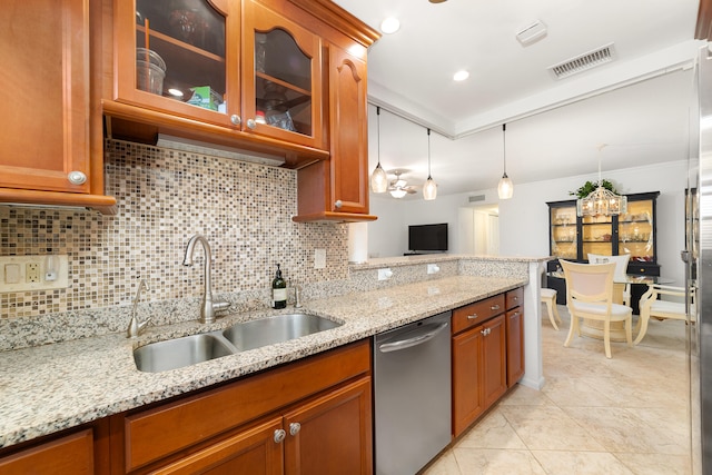 kitchen featuring dishwasher, light stone countertops, tasteful backsplash, and sink