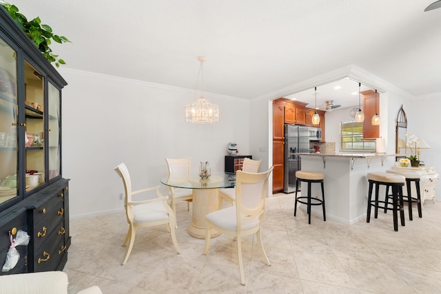 dining room with ornamental molding, an inviting chandelier, and light tile patterned floors