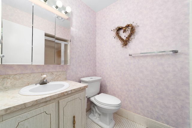 bathroom with tile patterned floors, vanity, and toilet