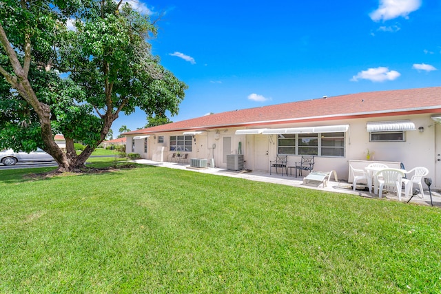 back of property featuring a patio and a lawn