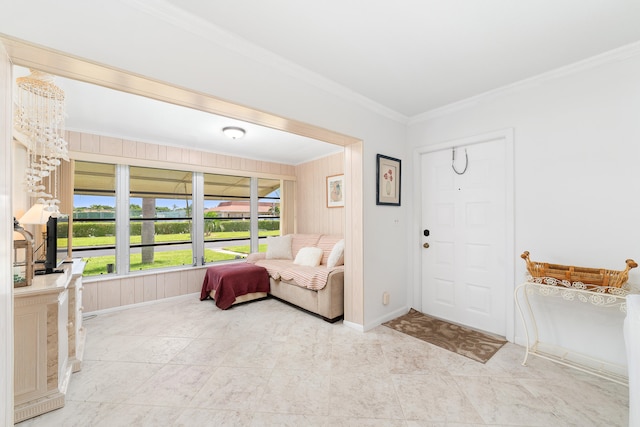 foyer entrance with wood walls and ornamental molding