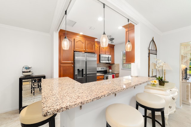 kitchen featuring pendant lighting, ornamental molding, kitchen peninsula, backsplash, and stainless steel appliances