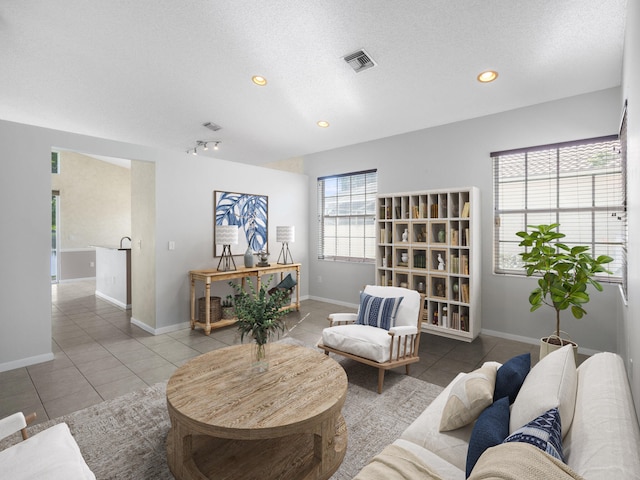 living room with tile patterned flooring and a textured ceiling