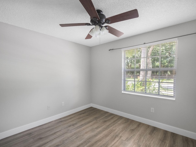 spare room with a textured ceiling, hardwood / wood-style flooring, and ceiling fan