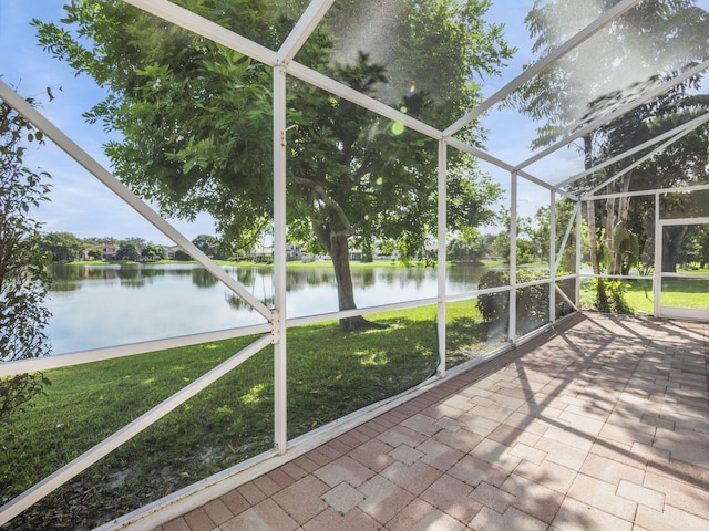 unfurnished sunroom with a water view