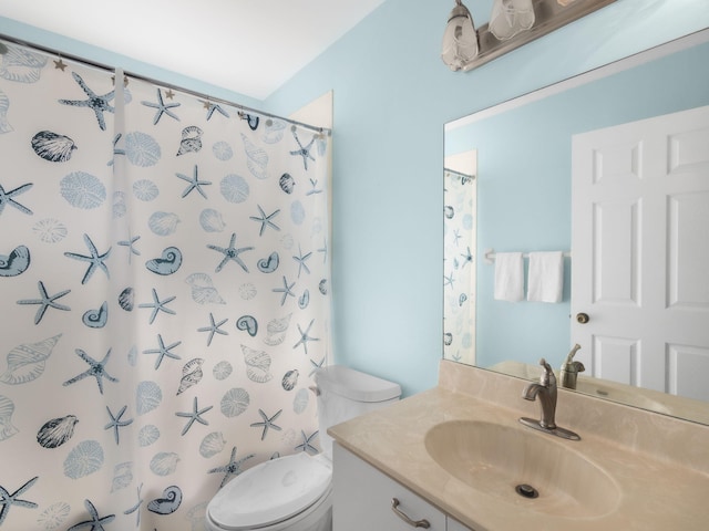 bathroom featuring vanity, toilet, and a shower with shower curtain