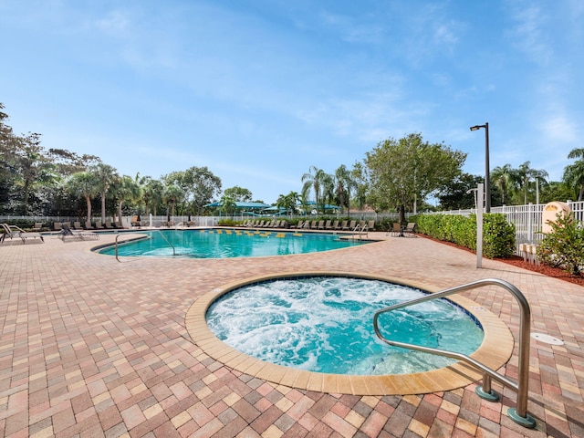 view of pool featuring a patio and a community hot tub