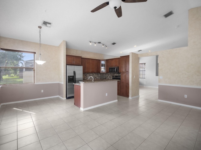 kitchen featuring appliances with stainless steel finishes, ceiling fan, light tile patterned floors, backsplash, and hanging light fixtures