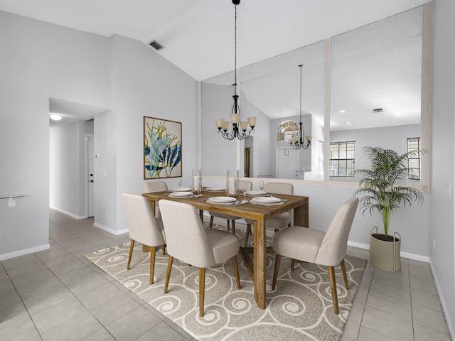 dining room with light tile patterned floors, lofted ceiling, and a notable chandelier