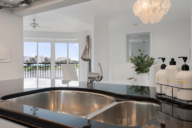 kitchen featuring ceiling fan and sink