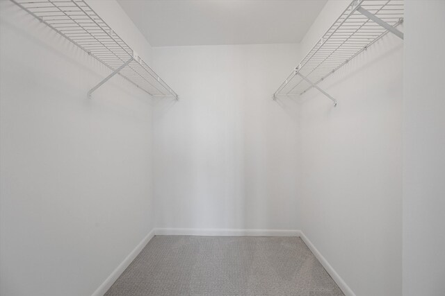 bathroom with walk in shower, tile patterned flooring, and vanity