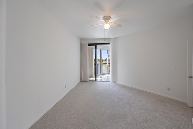 spare room with ceiling fan and light colored carpet