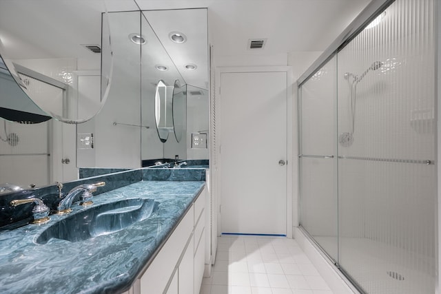 bathroom featuring walk in shower, vanity, and tile patterned floors