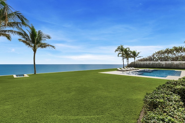 view of yard featuring a fenced in pool and a water view