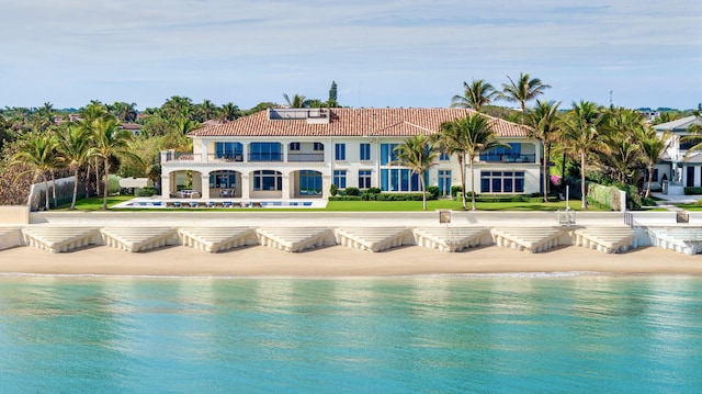 view of swimming pool with a water view and a view of the beach