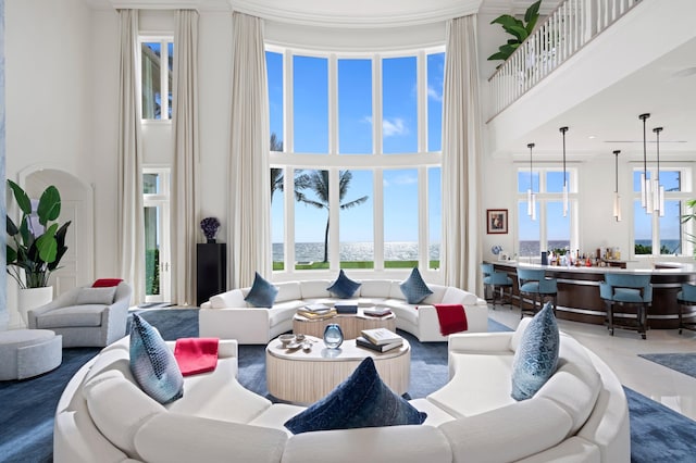 living room with ornamental molding and a high ceiling