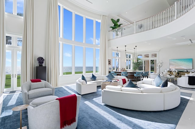 living room with a towering ceiling and a wealth of natural light