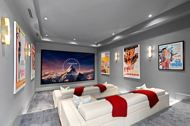 cinema room featuring a tray ceiling