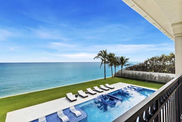 view of swimming pool featuring a water view, a patio, and a lawn