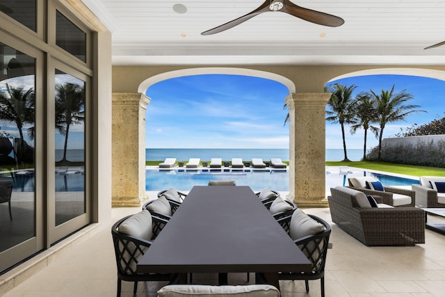 view of patio / terrace with a water view and ceiling fan