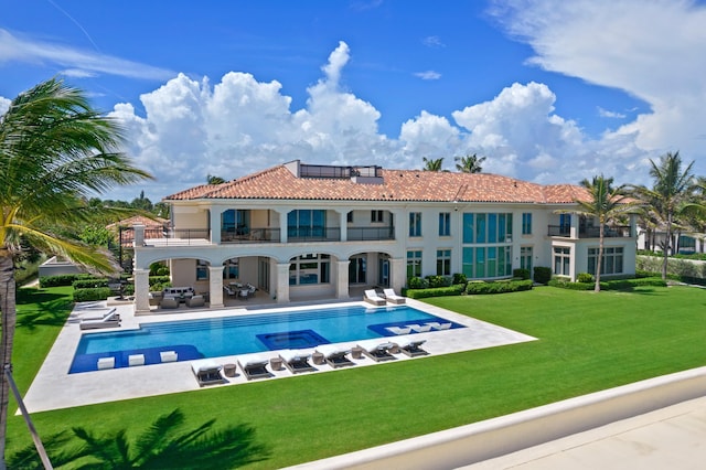 view of swimming pool with a patio area and a yard