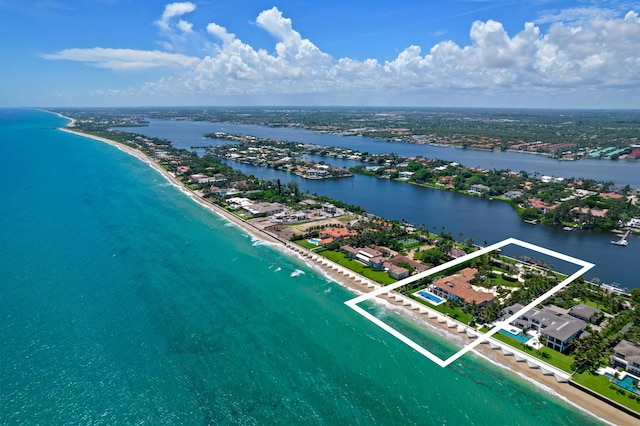 birds eye view of property with a view of the beach and a water view