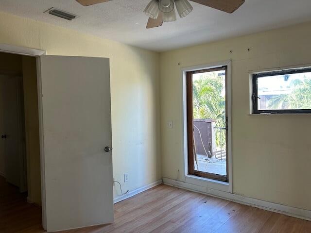 spare room featuring light hardwood / wood-style flooring and ceiling fan