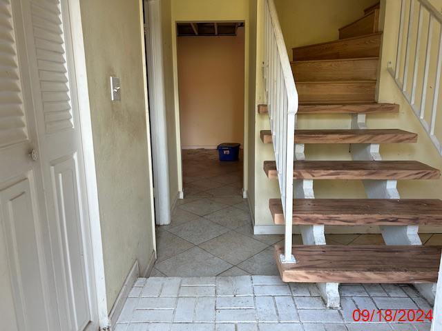 stairs with tile patterned flooring