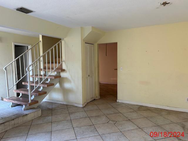 staircase featuring tile patterned floors