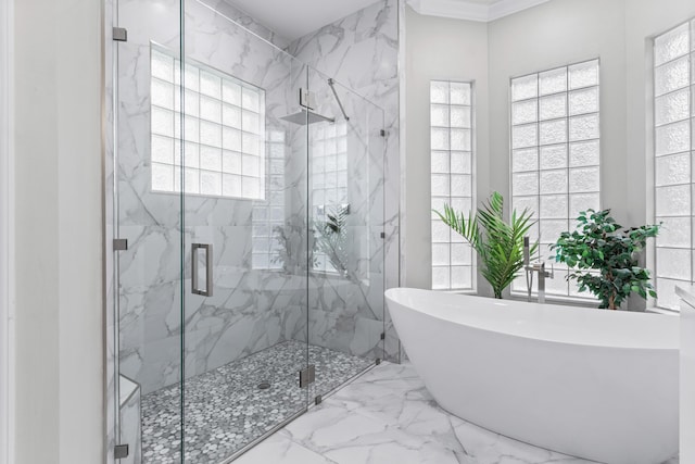 bathroom featuring a wealth of natural light and independent shower and bath