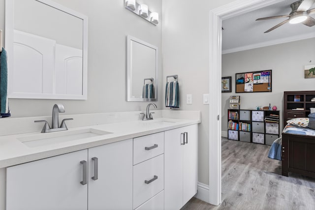 bathroom featuring hardwood / wood-style floors, vanity, crown molding, ceiling fan, and a textured ceiling